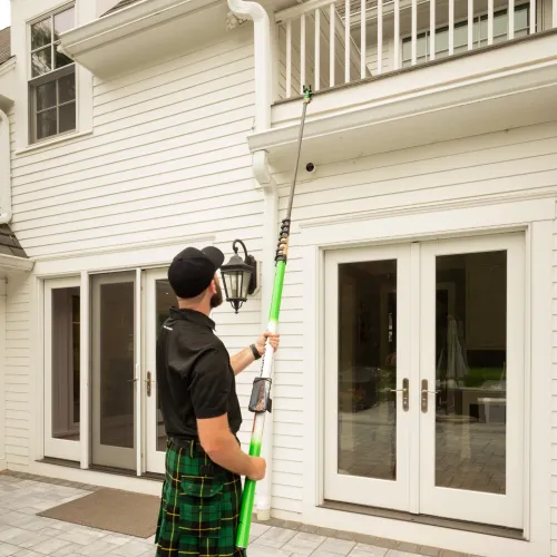 a person holding a gutter camera