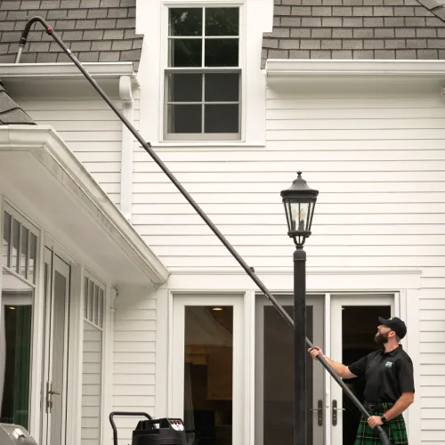 a man cleaning gutters