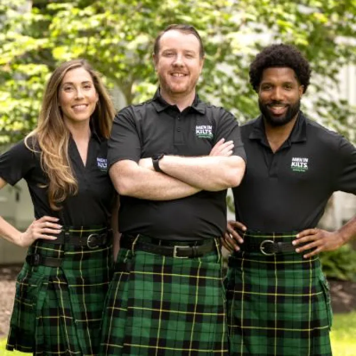 a group of people in kilts